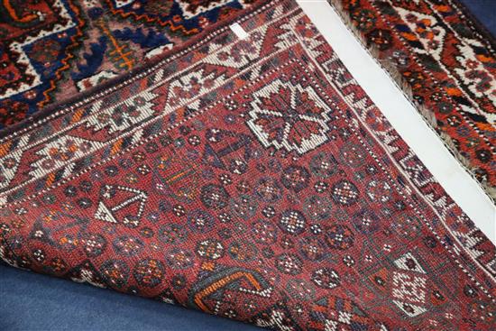 A Shiraz design red ground rug, 5ft 3in by 3ft 8in.